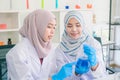 Professional distinguished Science specialist at work.Young Asian scientist with test tube making research in clinical laboratory Royalty Free Stock Photo