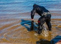 Professional diver near the river coastline. Commercial diving