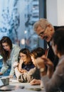 A professional diverse team collaborating during a business meeting in a contemporary well-lit office space. Royalty Free Stock Photo