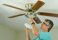 Professional or DIY home owner doing ceiling fan repair work Royalty Free Stock Photo