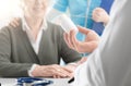 Professional doctor giving a prescription medicine to a senior patient Royalty Free Stock Photo