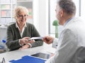 Professional doctor giving a prescription to a senior patient Royalty Free Stock Photo