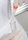 Professional doctor lab technician holding blood sample with novel covid-19 coronavirus glass pipette to test tube Royalty Free Stock Photo