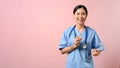 Professional doctor smiling to the camera while holding document in her hand Royalty Free Stock Photo