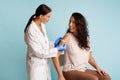 Doctor Vaccinating Patient Sticking Plaster On Vaccinated Arm Blue Background Royalty Free Stock Photo