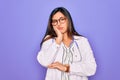 Professional doctor woman wearing stethoscope and medical coat over purple background thinking looking tired and bored with Royalty Free Stock Photo