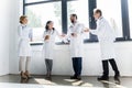 professional doctors in white coats talking and drinking Royalty Free Stock Photo