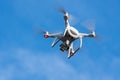 Professional drone quad copter DJI Phantom 4 Pro with digital camera flight in deep blue sky, photographs world around Royalty Free Stock Photo