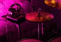 Professional drum kit and headphones on stage in night club