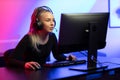 Professional E-sport Gamer Girl with Headset Playing Online Video Game on PC Royalty Free Stock Photo