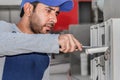 A professional electrician man is repairing a main switch of heavy power supply line circuit board