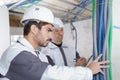 Professional electrician with student on construction site Royalty Free Stock Photo