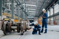 Professional electricity train rail engineer worker working train service inspector checking track rail system in train depot Royalty Free Stock Photo