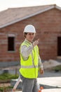 Professional engineer architect worker with protective helmet at house building construction site background Royalty Free Stock Photo