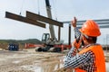 Engineer directing a heavy construction crane on a job site. Royalty Free Stock Photo
