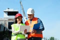 Professional engineer and foreman in safety equipment with tablet Royalty Free Stock Photo