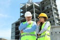 Professional engineer and foreman with tablet in safety equipment Royalty Free Stock Photo