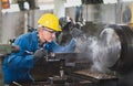 Male engineer metalworker operating workpiece for prototype product at a factory