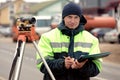 Professional engineer surveyor during road works with tacheometer theodolite tool Royalty Free Stock Photo