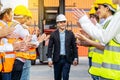 Professional Engineering and worker team congratulated success by applaud their jubilant leader after construction project