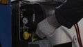 Professional equipment at the car repair center. Scene. Close up of man hands using inflate compressor and and air Royalty Free Stock Photo