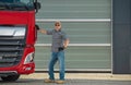 Professional Euro Trucker and His Brand New Semi Tractor Truck Royalty Free Stock Photo