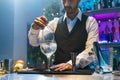 Professional expert barman making cocktail in the counter bar at party in nightclub. Nightlife concept. Royalty Free Stock Photo