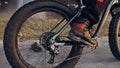 Professional extreme sportsman biker riding fat bike in outdoor. Close-up view of rear wheel. Cyclist ride in winter