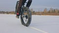 Professional extreme sportsman biker riding fat bike in outdoor. Cyclist ride in winter snow forest. Man does trial