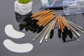 Professional eyelash extension accessories arranged on mirror creating beauty salon workspace concept Royalty Free Stock Photo