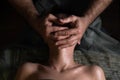 Professional facial massage. Male masseur makes procedures on a female face on a dark background Royalty Free Stock Photo