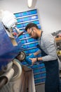 Professional facilty worker using a grinding machine at a shoemaker Royalty Free Stock Photo