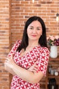 Professional family doctor psychologist in glasses is sitting in the office in the loft style and smiling at the camera.