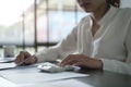 Professional female accountant using calculator and checking financial reports at office desk Royalty Free Stock Photo