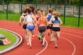 Professional female athletes competition on athletics track, track and field, running photo