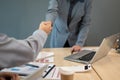 A professional female boss is shaking her hand with a young businessman during the meeting Royalty Free Stock Photo