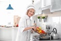 Professional female chef cooking vegetables Royalty Free Stock Photo