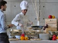 Professional female chef prepares buffet food for customers