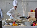 Professional female chef prepares buffet food for customers