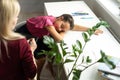 Professional female child psychologist working with a little preschool girl in a bright office. Woman makes notes Royalty Free Stock Photo