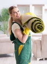 Professional female cleaner cleaning carpet Royalty Free Stock Photo