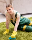 Professional female cleaner cleaning carpet Royalty Free Stock Photo