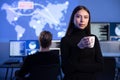 Professional Female IT Consultant holding coffee cup in large Cyber Security Operations Center SOC handling Threats Royalty Free Stock Photo