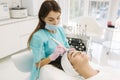 Professional female cosmetologist doing hydrafacial procedure in Cosmetology clinic. Doctor use hydra vacuum cleaner Royalty Free Stock Photo