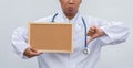 Professional female doctor in white coat over white isolated background and white blank board and Thumbs down. Concept of healthca Royalty Free Stock Photo