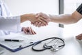 Professional female doctor in white coat shaking hand with patient after successful recommend treatment methods after results Royalty Free Stock Photo