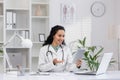 Female doctor consulting via tablet in modern clinic office Royalty Free Stock Photo