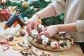 Female florist decorator making Christmas wreath Royalty Free Stock Photo