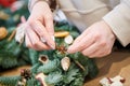 Female florist decorator making Christmas wreath Royalty Free Stock Photo