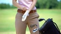 Professional female golf player wearing glove before competition, elite hobby Royalty Free Stock Photo